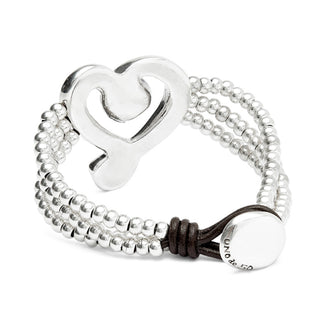 Silver bracelet with heart charm and beads on a white background