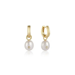 A pair of gold-colored pearl drop huggie hoop earrings with a single cubic zirconia stone.