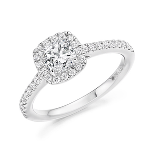 A platinum diamond engagement ring with a cushion-cut center stone surrounded by a double halo, and a pavé-set band, shown on a white background.