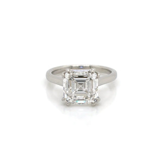 Diamond ring with a rectangular cut gemstone on a white background