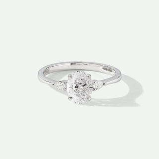 Diamond ring with a oval-shaped center stone on a light gray background