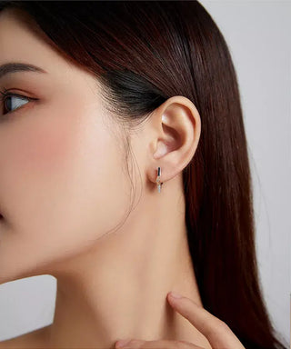 Women wearing a pair of Silver Star Outline Hoop Earrings