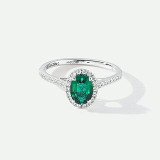 Silver ring with a green gemstone on a white background