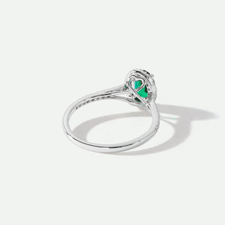 Silver ring with a green gemstone on a white background