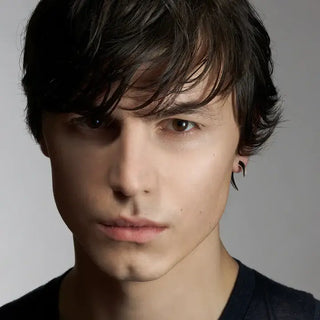 a man wearing a pair of shaun leane black ceramic hook earrings