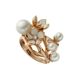 Rose gold ring with pearls and floral design on a light gray background