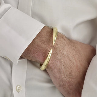 Gold cufflinks on a person wearing a white shirt