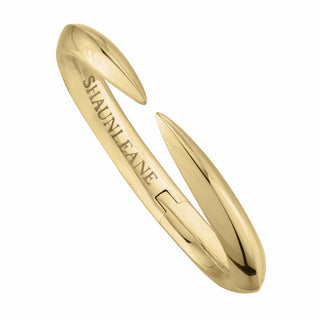 Gold bracelet with 'Shaun Leane' branding on a white background