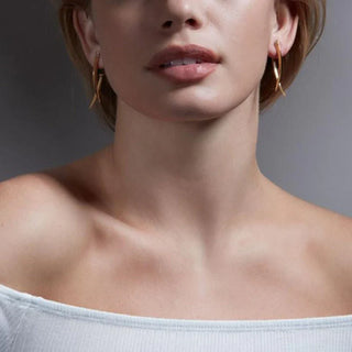 Close-up of a woman's neck and shoulders with a neutral background