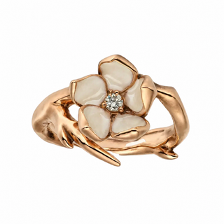Rose gold ring with floral design and diamond on a white background