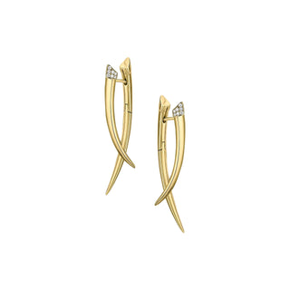 Gold earrings with a geometric design on a light gray background