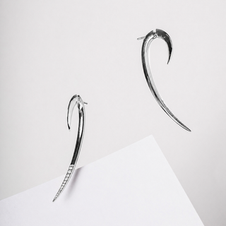 Pair of silver hoop earrings on a light gray background