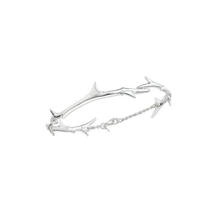 Silver bracelet with branch-like design on a white background
