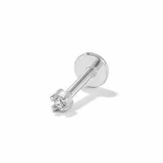 A silver-toned labret piercing stud with a small clear gemstone in a prong setting, shown on a clean white background with a soft shadow.