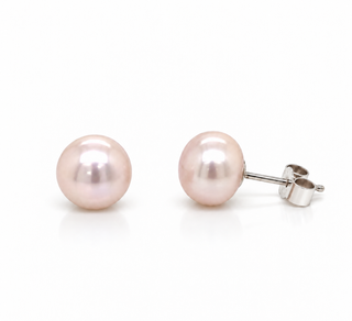 A pair of round light pink freshwater pearl stud earrings with silver posts and butterfly backings, displayed on a clean white background.