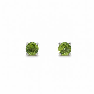 Pair of green round earrings on a white background