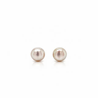 A pair of round freshwater pearl stud earrings with a soft pinkish-white luster, displayed on a clean white background.