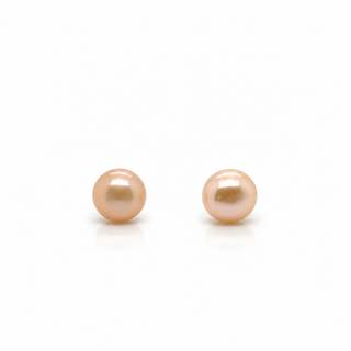 A pair of round freshwater pearl stud earrings in a soft peach-pink color, displayed on a clean white background.