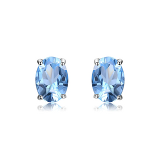 A pair of silver oval-shaped stud earrings with blue topaz stones.