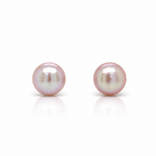 A pair of round freshwater pearl stud earrings with a soft pink luster and subtle iridescence, displayed on a clean white background with a soft reflection below.