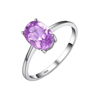 An oval-cut light purple gemstone ring set on a polished silver band, shown against a light gray background. The inner band is marked 'S925' for sterling silver.