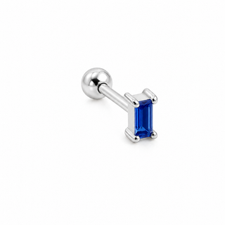A silver-toned labret piercing stud featuring a rectangular baguette-cut blue gemstone in a prong setting, shown on a clean white background.