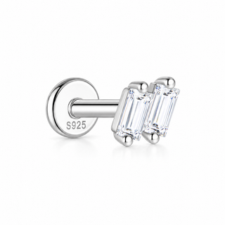A pair of silver-toned stud earrings with baguette-cut clear gemstones, shown on a clean white background. One earring is turned to show the back with 'S925' stamped on the metal post, indicating sterling silver.
