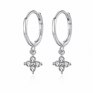A pair of sterling silver hoop earrings with dangling floral cross charms set with clear stones, shown on a clean white background.