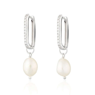 A pair of hoop earrings with cubic zirconia decorations and a white freshwater pearl hanging below.
