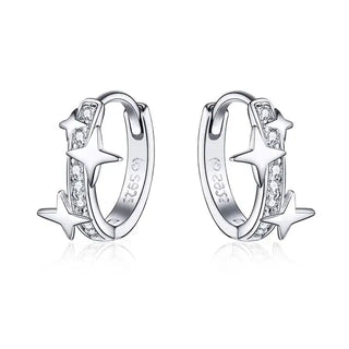 A pair of silver starburst-shaped hoop earrings with cubic zirconia accents.