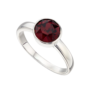 Silver ring with a red gemstone on a white background