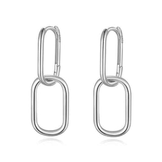 A pair of silver double hoop drop earrings against a white background.