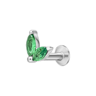 Silver earring with green gemstones on a white background