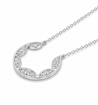 Silver necklace with a crescent moon pendant on a white background
