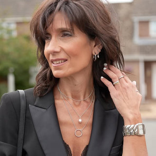 Woman wearing jewelry outdoors with a blurred background