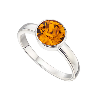 Silver ring with a round orange gemstone on a white background