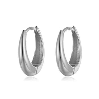 A pair of silver oval tapered hoop earrings.