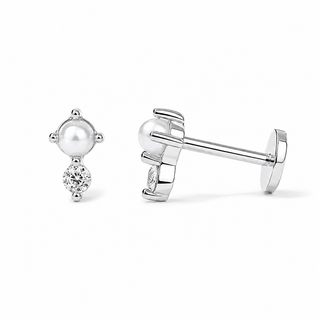 A pair of silver stud earrings featuring a round white pearl and a small clear gemstone, shown on a clean white background with one earring facing forward and the other in side profile.