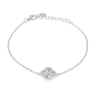 A delicate silver chain bracelet with a central clover-shaped charm adorned with small clear stones, displayed on a neutral gray gradient background.