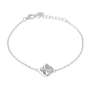A delicate silver chain bracelet with a central clover-shaped charm featuring a sunburst pattern, displayed on a neutral gray gradient background.