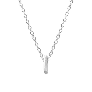 Silver necklace with a cylindrical pendant on a white background