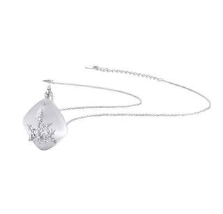 Silver necklace with a teardrop-shaped pendant on a white background