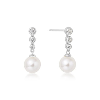 Pearl and diamond earrings on a white background