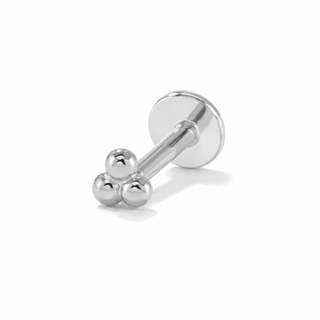 A silver-toned labret piercing stud with three small spherical beads clustered at the end, shown on a clean white background.
