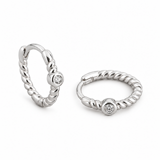 A pair of silver huggie hoop earrings with a twisted rope texture and a small round clear gemstone set in the center, displayed on a clean white background.