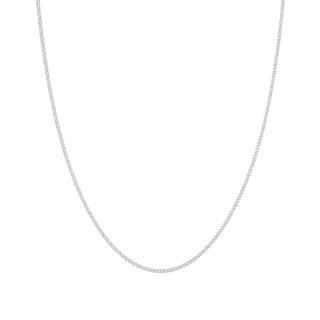 A delicate silver chain necklace, shown draped in a U-shape against a solid off-white background.