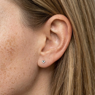 Close-up of an ear with a small stud earring.