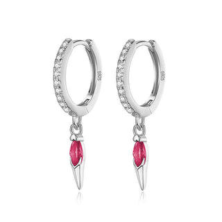 A pair of dark pink cubic zirconia stud earrings with a metallic silver or gold plated band.