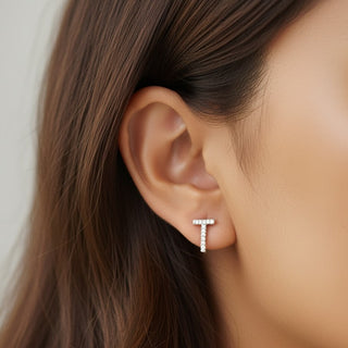 Close-up of an ear wearing a cz stud earring with a blurred background