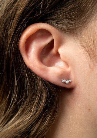 Model wearing 3 stone titanium labret piercing stud - BFF Titanium Graduated Crystal Flat Back Stud Earrings